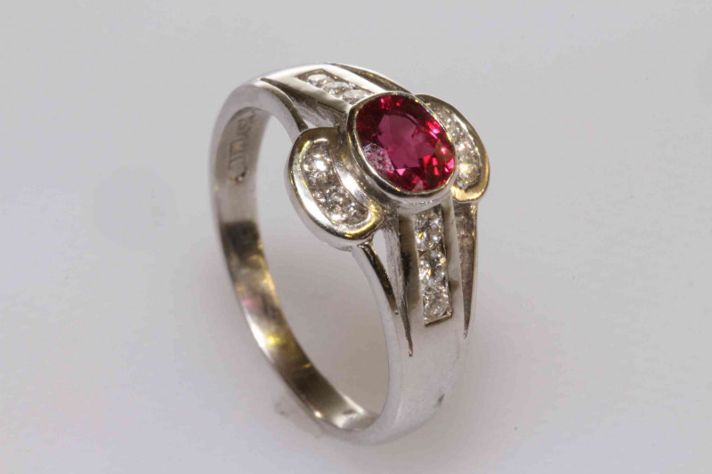 18 carat gold, oval ruby and brilliant cut diamond ring, size K