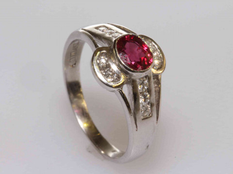 18 carat gold, oval ruby and brilliant cut diamond ring, size K