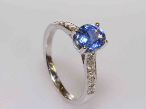 18 carat gold, oval sapphire and round brilliant cut diamond shoulder...