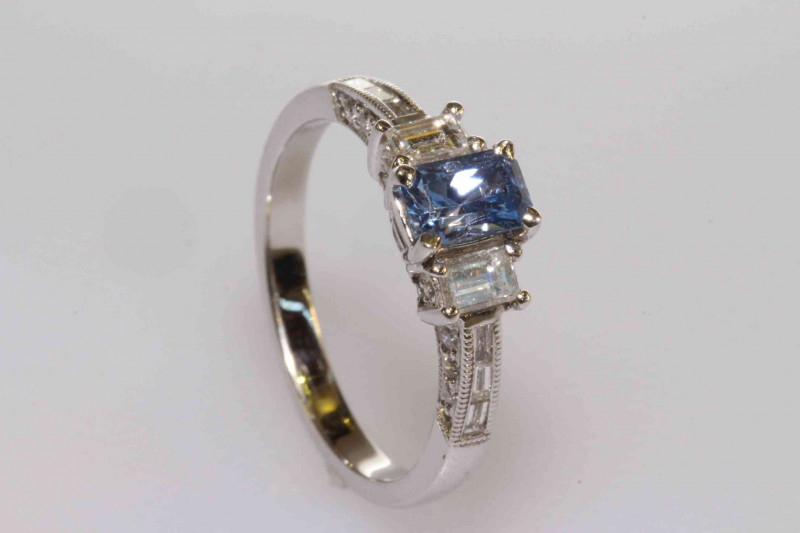 18 carat gold, emerald cut tanzanite and diamond shoulder ring, size L