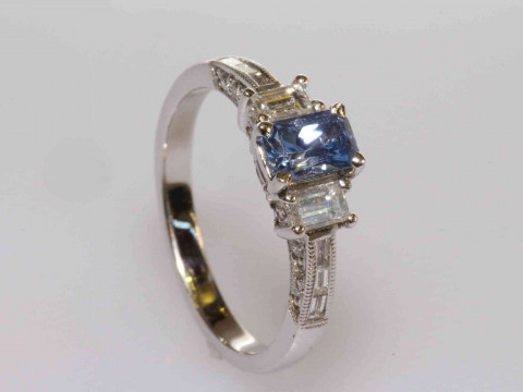 18 carat gold, emerald cut tanzanite and diamond shoulder ring, size L