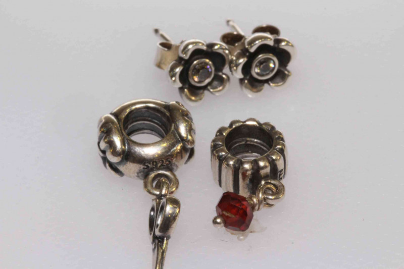 Two Pandora charms and a pair of silver earrings