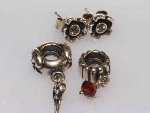 Two Pandora charms and a pair of silver earrings
