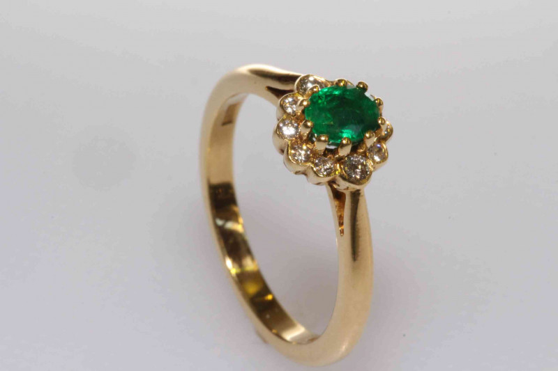 18 carat gold oval emerald and round brilliant diamond cluster ring, size M½