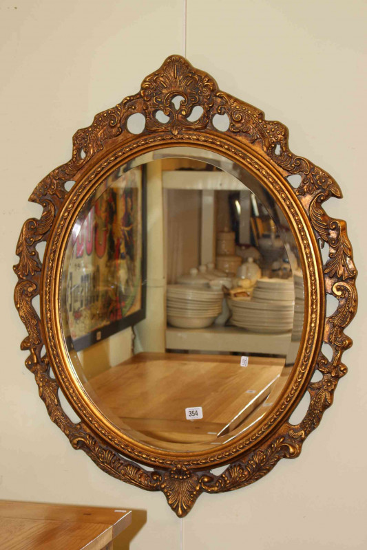 Gilt framed oval mirror