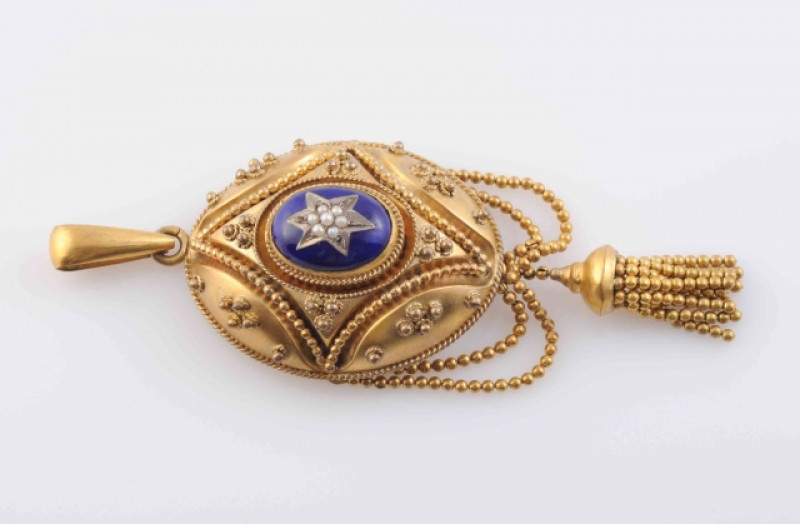 A MID 19TH CENTURY SEED PEARL AND ENAMEL LOCKET PENDANT, the large oval moulded mount with elaborate symmetrical beaded and scroll detail metal work, set to the centre with a raised oval mount of dark blue enamelling with central star shaped mount set wit