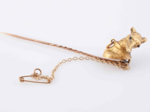 A MID VICTORIAN STICK PIN, modelled as the head of a greyhound with moulded articulated collar set with a single turquoise highlight, with attached safety chain. In fitted case. Length 7cm. Weight 4.9 grams thumbnail