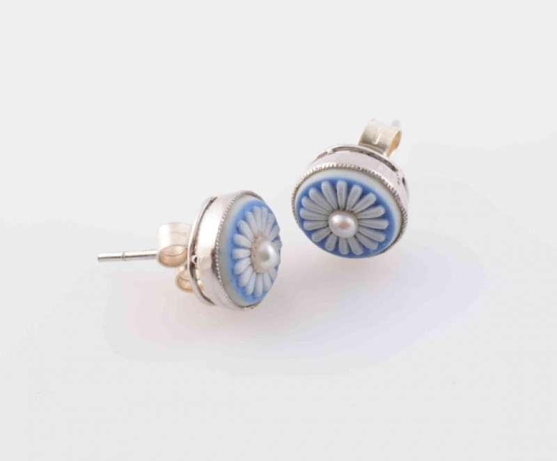 A PAIR OF ENAMEL AND SEED PEARL STUD EARRINGS, each circular mount of blue and white floral detail enamelling set to the centre with a single seed pearl highlight, on post and scroll fittings. Total weight 2.4 grams.