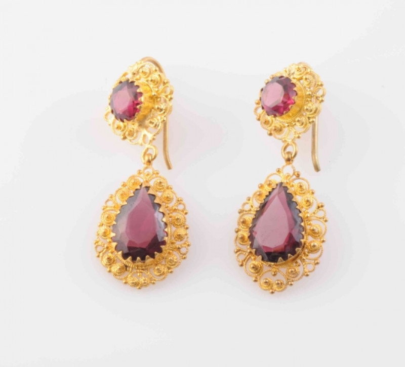 A PAIR OF TOURMALINE SET EARRINGS, CIRCA 1870-1880, the pear cut tourmaline claw set within an elaborate but delicate mount of coiled and beaded detailed textured metal, suspending on an articulated link from a further round cut tourmaline claw set within