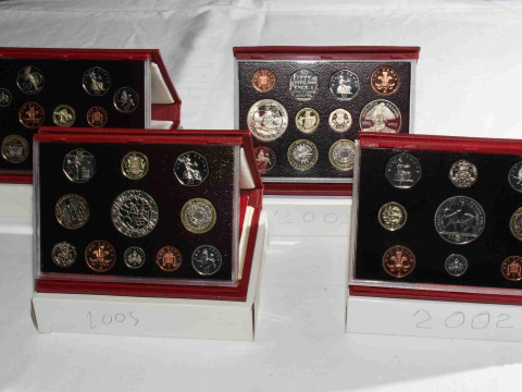 Four Royal Mint Proof coin sets, 2002, 2003, 2004 and 2005