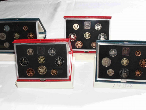 Four Royal Mint Proof coin sets, 1983, 1984, 1985 and 1986