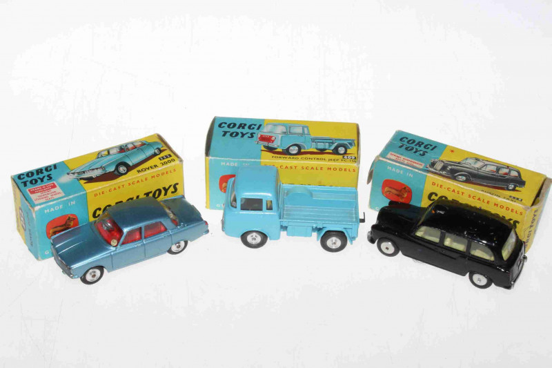 Three Corgi models, Rover 2000 252, Austin Taxi 418 and Forward Control Jeep 409, with boxes