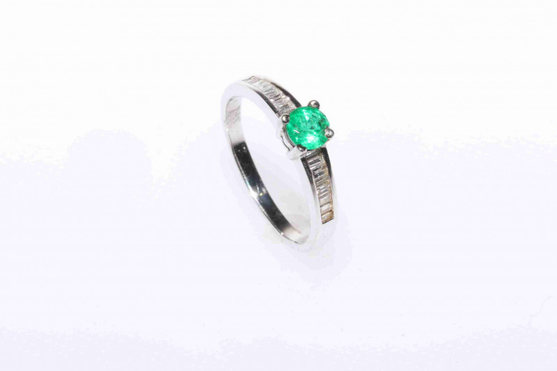 Platinum, round emerald and channel set baguette diamond ring, size M