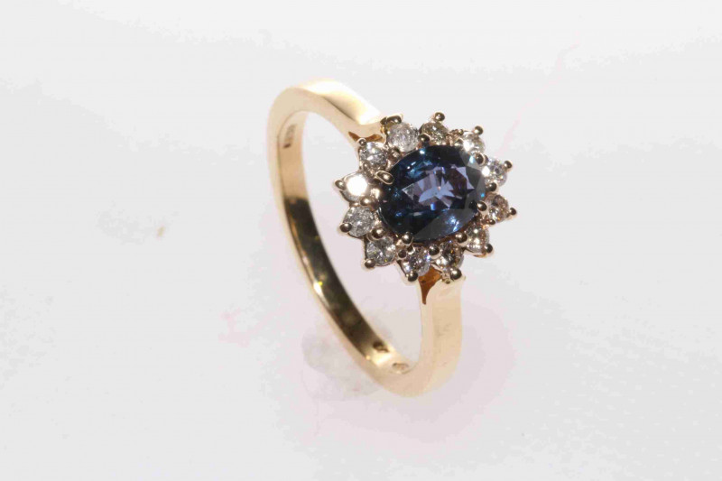18 carat yellow gold, oval sapphire and round brilliant diamond cluster ring, size M½