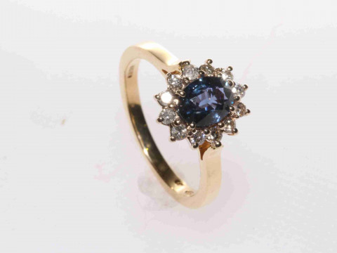 18 carat yellow gold, oval sapphire and round brilliant diamond cluster...