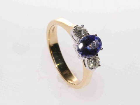 18 carat yellow gold, oval tanzanite and round brilliant diamond three-stone...