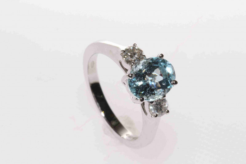 18 carat gold, aquamarine and round brilliant diamond three-stone ring, size L