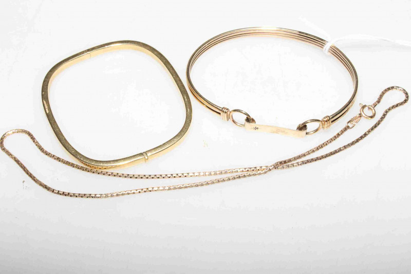 18 carat gold hinged bangle, 10.5 grams; 9 carat gold bangle, 10.2 grams; and a 9 carat gold chain, 6.5 grams