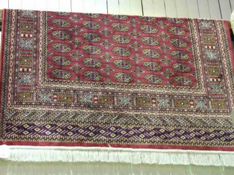 Bokhara rug with a red ground 1.90 by 1.40