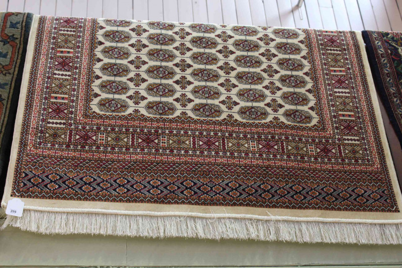 Bokhara rug with a beige ground 1.90 by 1.40