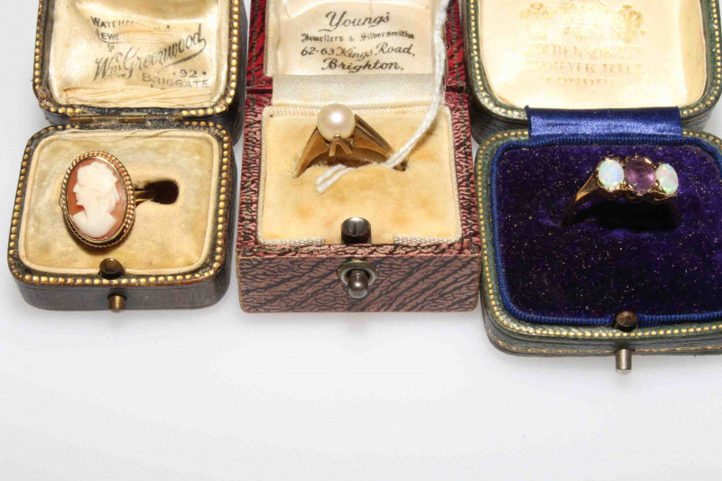 Three 9 carat gold rings, pearl, cameo and amethyst with opal