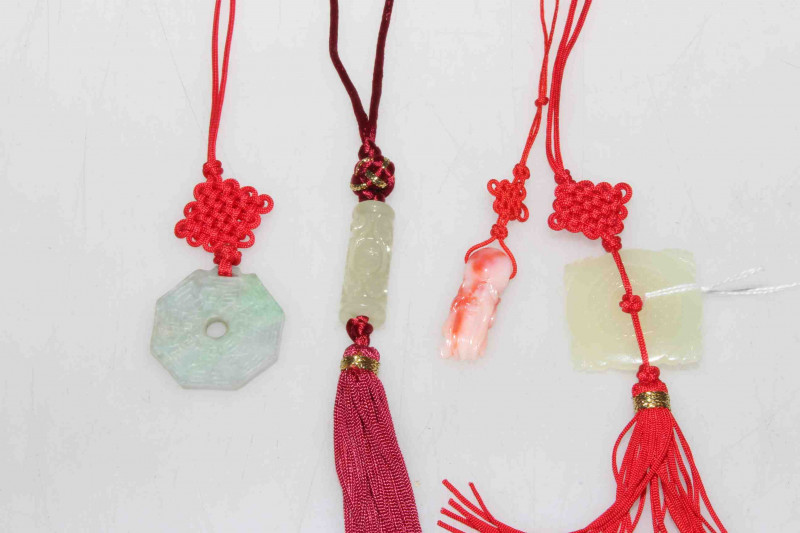 Four fabric and jade necklaces, three green and one red