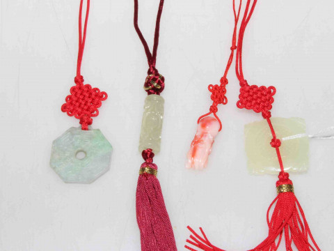 Four fabric and jade necklaces, three green and one red