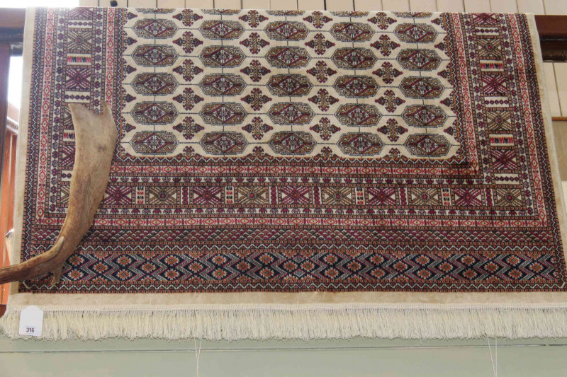 Beige ground Bokhara rug 1.90 by 1.40