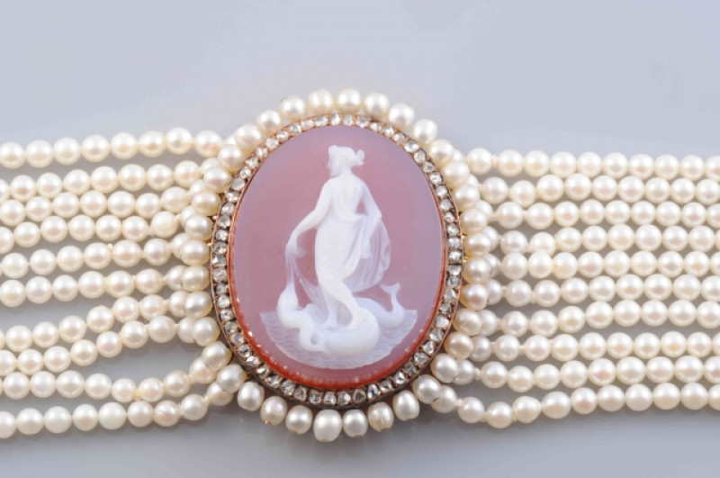 A LATE 19TH CENTURY PEARL, DIAMOND AND HARDSTONE CHOKER, the uniform pearls each strung knotted into ten graduating rows with two rectangular old cut diamond set spacers and a similarly set rectangular clasp, set to the front with an oval mount set to the