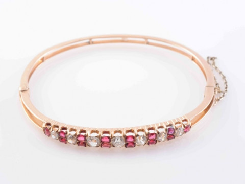 A LATE 19TH CENTURY SPINEL AND DIAMOND BANGLE, the seven graduating brilliant...