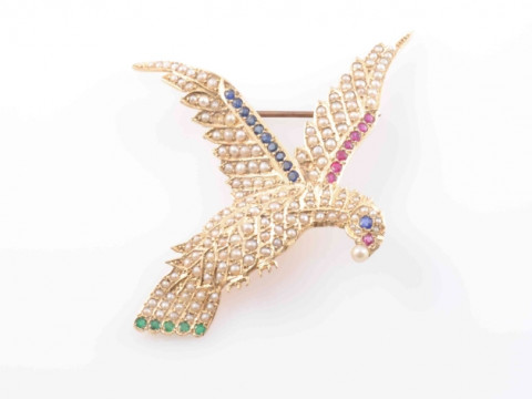 A SEED PEARL, EMERALD, RUBY AND SAPPHIRE BROOCH, modelled as a bird in...