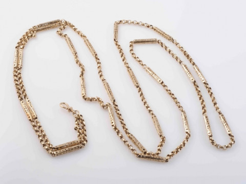 A LATE VICTORIAN ROSE GOLD GUARD CHAIN, of circular links evenly spaced...