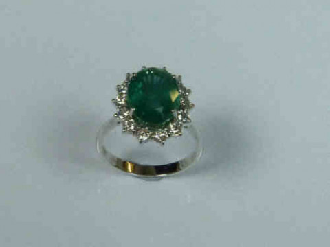 Emerald and Diamond Cluster Ring with an 18ct White Gold Band, the Emerald...