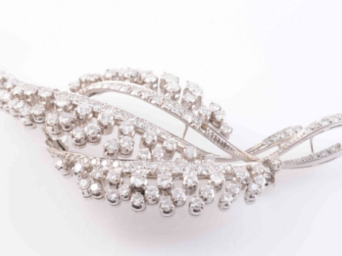 A DIAMOND SET BROOCH, formed as a floral spray, set throughout with seventy-five...