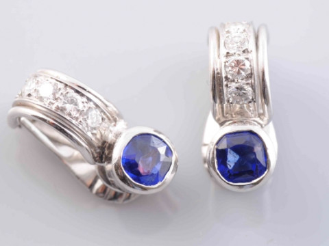 A PAIR OF SAPPHIRE AND DIAMOND EARRINGS, the single round cut collet set...