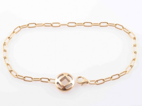 A YELLOW GOLD BRACELET BY CARTIER, of simple chain link form, with lobster...