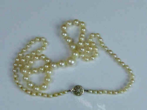 String of Graduated Pearls with a Diamond Set Clasp Stamped 9ct and PT,...