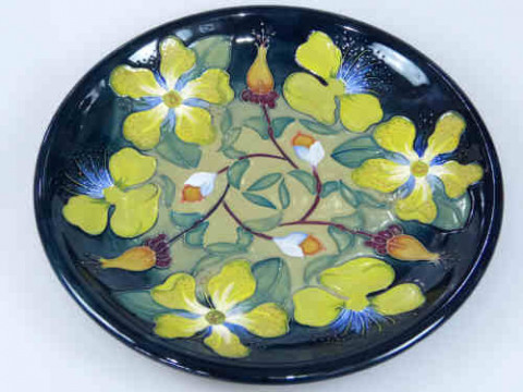 Modern Moorcroft Plate, floral design on blue green ground, 26cm dia.