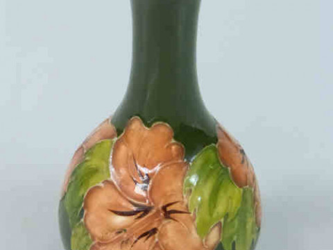 Moorcroft Vase decorated with hibiscus on green ground, 15.5cm high