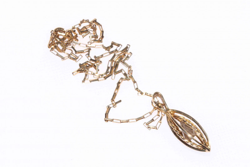 9 carat gold chain, suspending a 9 carat gold openwork pendant, apparently containing an uncut diamond (unwarranted)