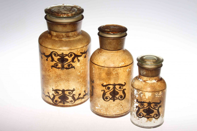 Three graduating decorated glass jars
