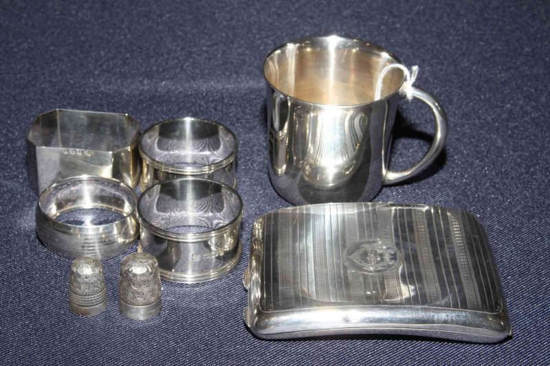 Silver christening tankard, silver cigarette case, four silver napkin rings, etc