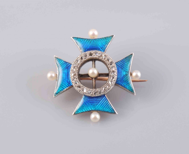 AN ENAMEL AND SEED PEARL BROOCH, circa 1880-1890, the single seed pearl highlight set to the centre of an open work circular mount set throughout with old cut diamond highlights, within four moulded triangular mounts set with blue and green enamel pattern