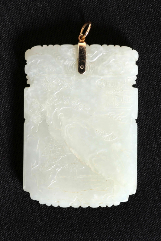 A CHINESE CARVED JADE PENDANT, rectangular, decorated to one side with a river landscape, to the other an archaic design. 6cm by 4cm