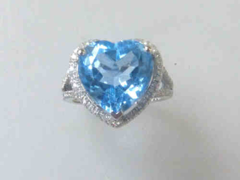 Blue Topaz and Diamond Ring, the heart shaped topaz approximately 6.75ct, on a 14ct White Gold Band, approximate weight of diamonds 0.5 carats, Size L 1/2