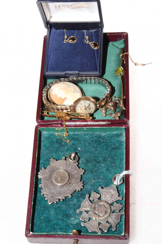 Collection of jewellery including gold bar brooches, wristwatch, cameo, pendant, and silver medallions