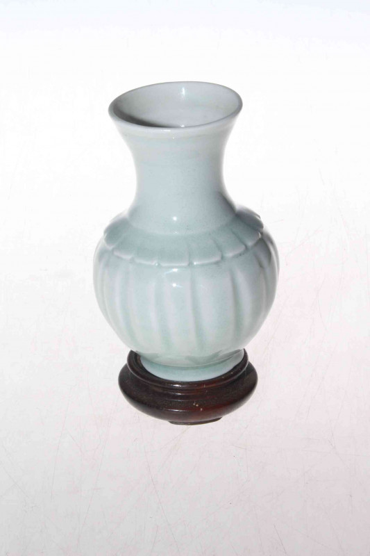 Chinese Qingbai green white Celadon glaze porcelain baluster vase, with fluted body, 11.5cm high, bearing possible collection number on base and with wood stand.