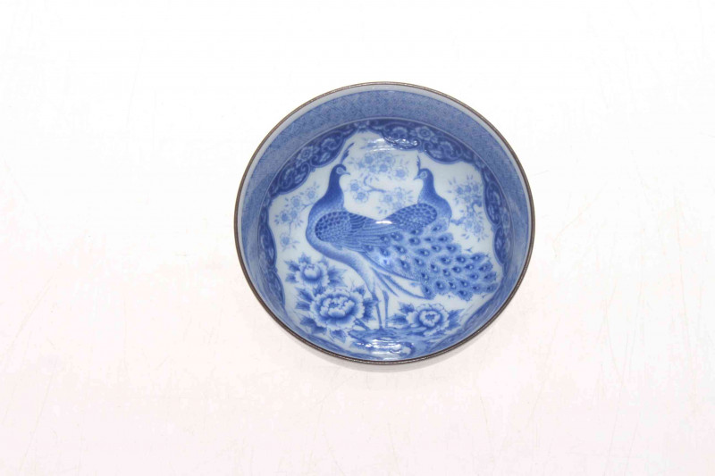 Oriental porcelain tea bowl, with fine interior blue and white decoration of peacocks and foliage, brown glazed exterior, 9cm diameter.