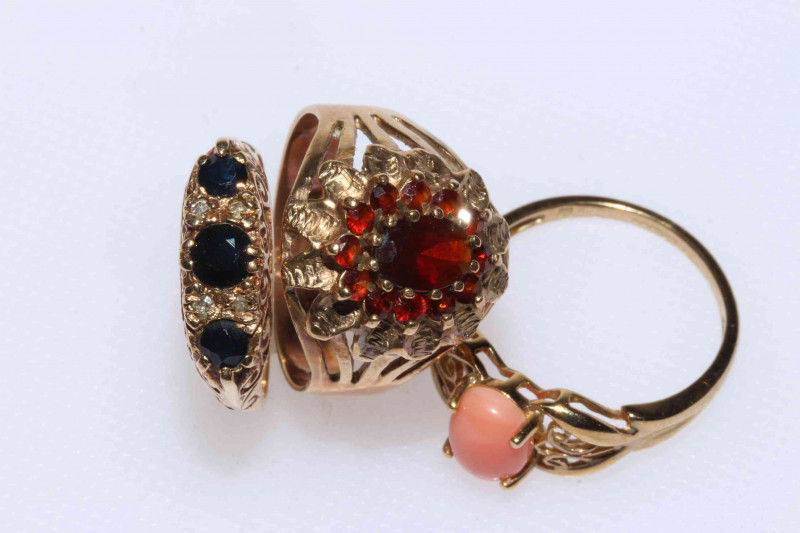 Three 9 carat gold rings; coral, garnett and sapphire and diamond.