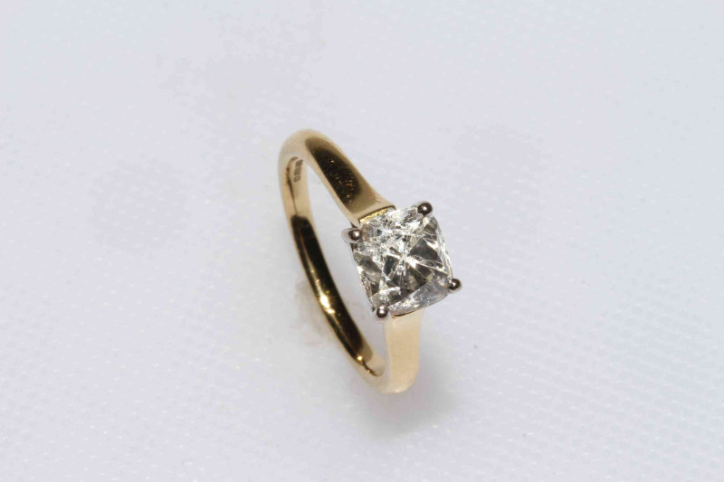 18 carat gold solitaire diamond ring, the cushion shaped diamond approximately 1.40 carat, size J.